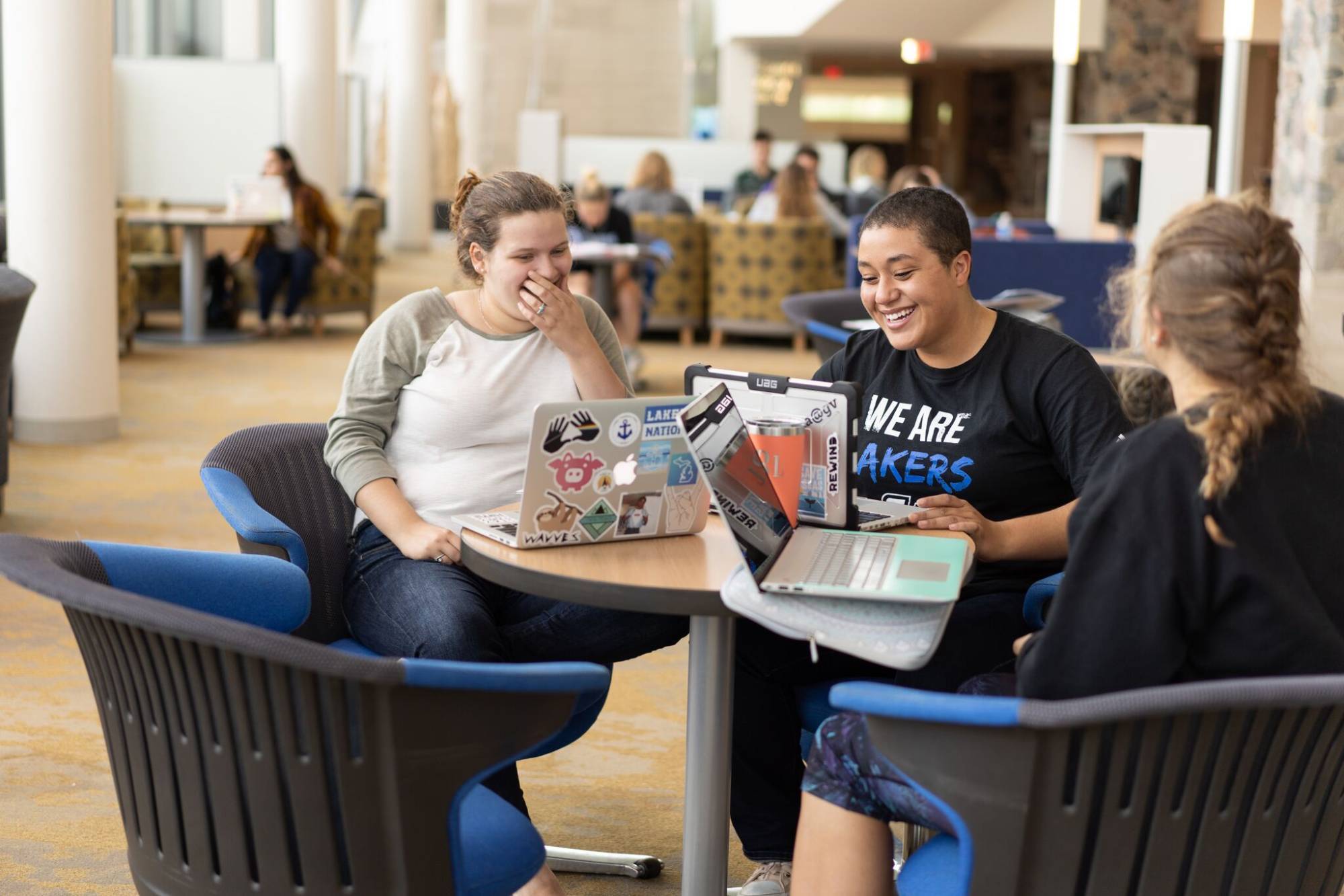Students laughing and enjoying studying in the library